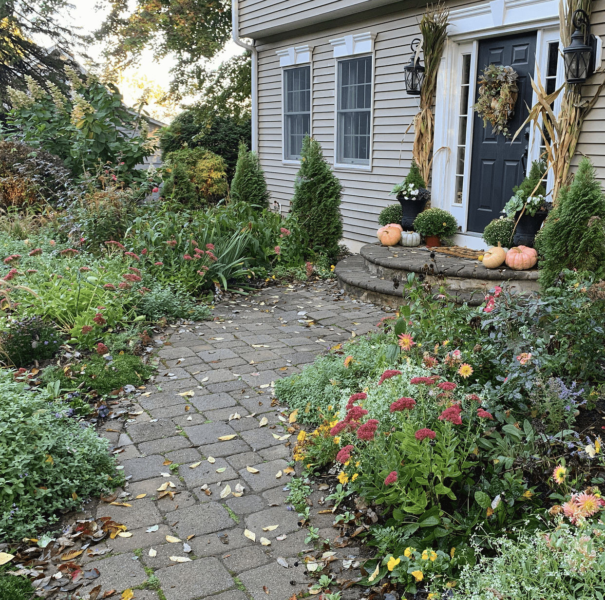 front porch in fall with pumpkins and cornstalks on beautiful autumn day in the gardenPreparing the Garden for Fall