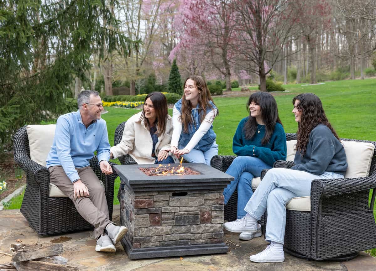 nj home and garden blogger stacy ling and her family spending time together around the firepit in the gardens