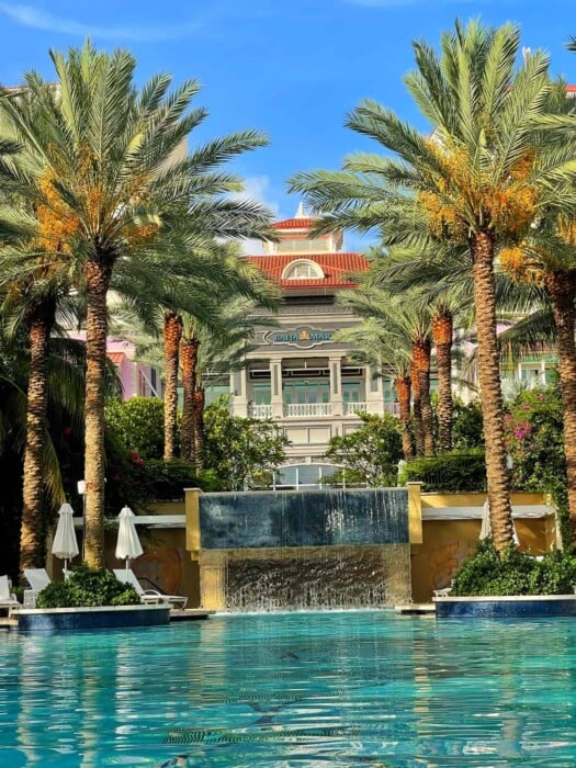 the baha mar pool and hotel with palm trees