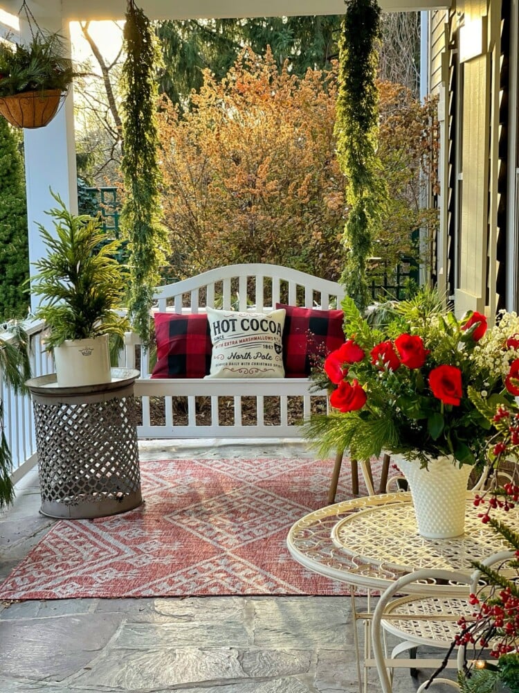 front porch Christmas Decor with red roses in milk glass vase