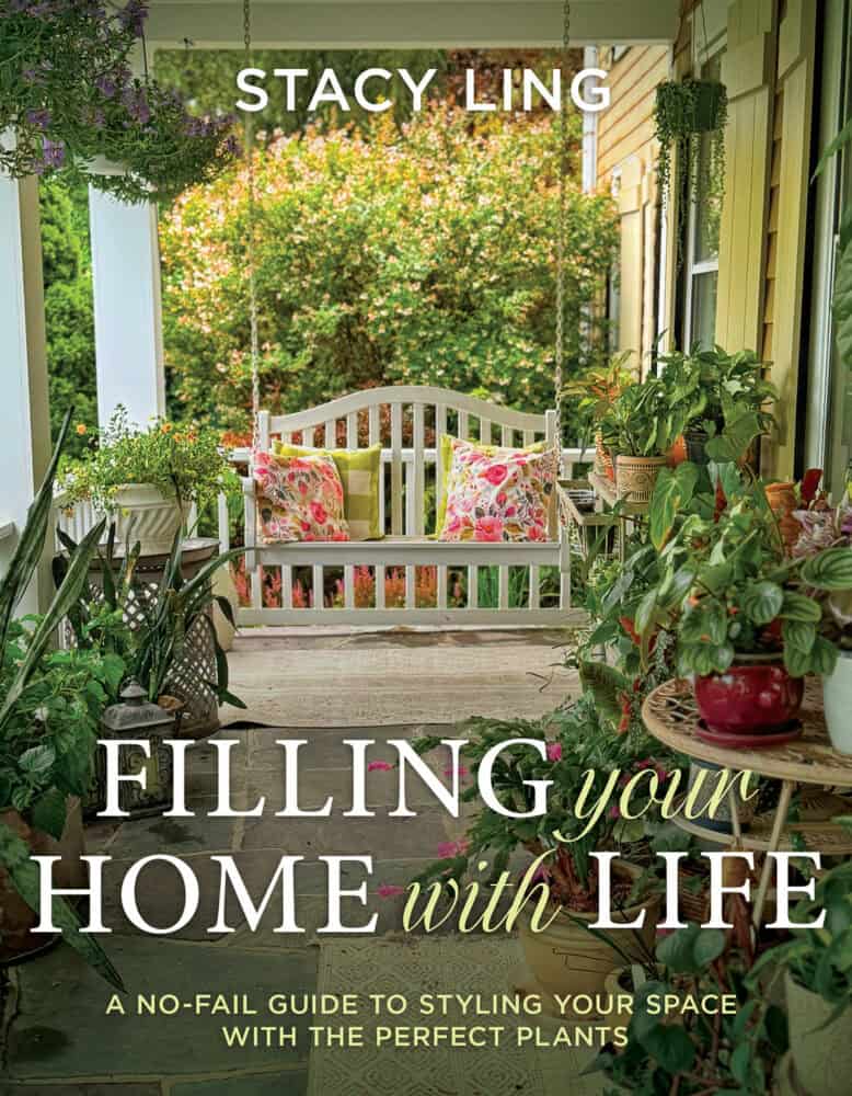 Book cover for "Filling Your Home with Life" by Stacy Ling, showing a cozy porch with a white swing bench, floral cushions, potted plants, and greenery in the background. Subtext: a guide to styling your space with plants.