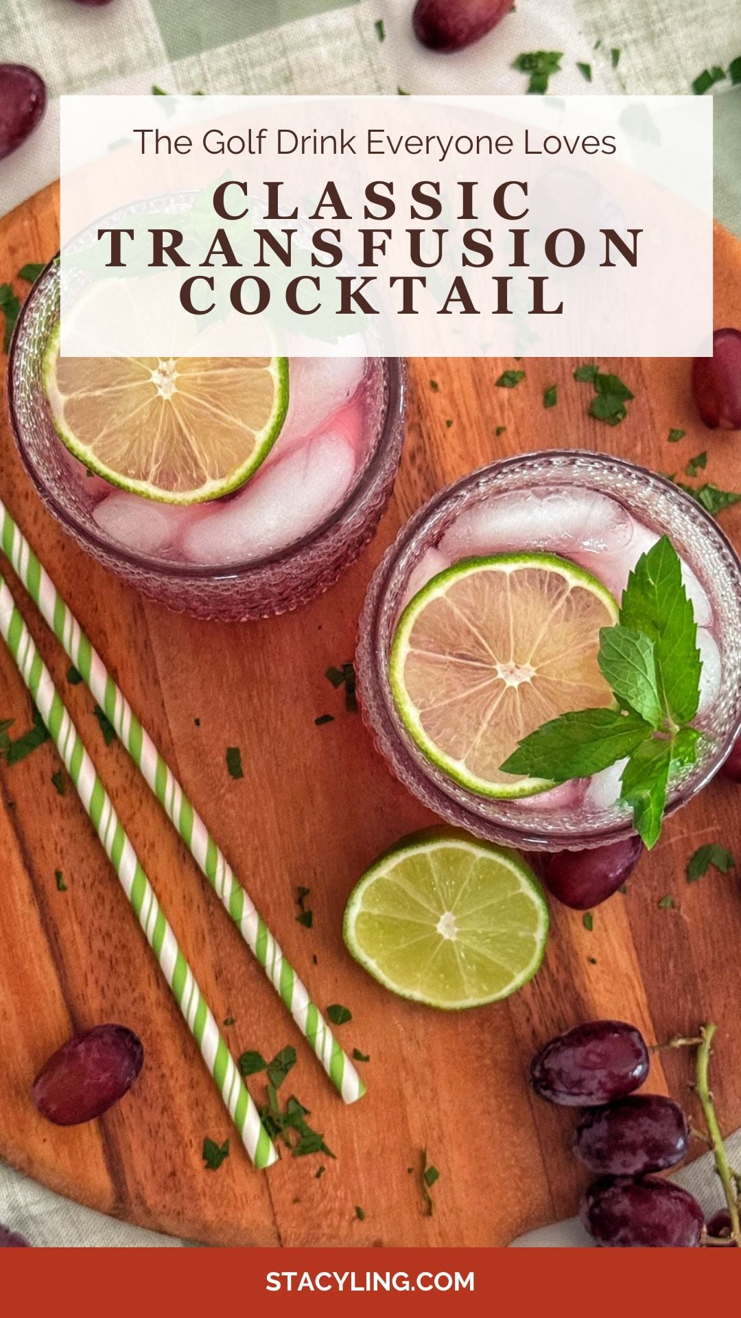 Two glasses of classic transfusion cocktail with ice, lime slices, and mint on a wooden board, surrounded by grapes and two green-striped straws showcase the vibrant allure of this refreshing transfusion cocktail.
